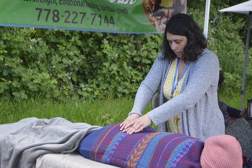 A practitioner offering a wellness session at a past festival