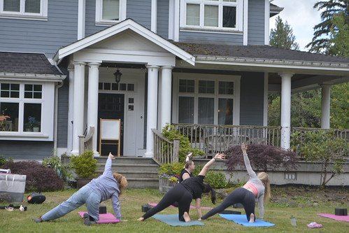 People practising yoga together outdoors at a past Living Well Festival