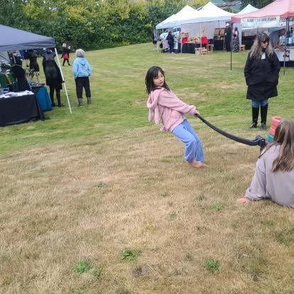 A child enjoying an outdoor swing at the festival